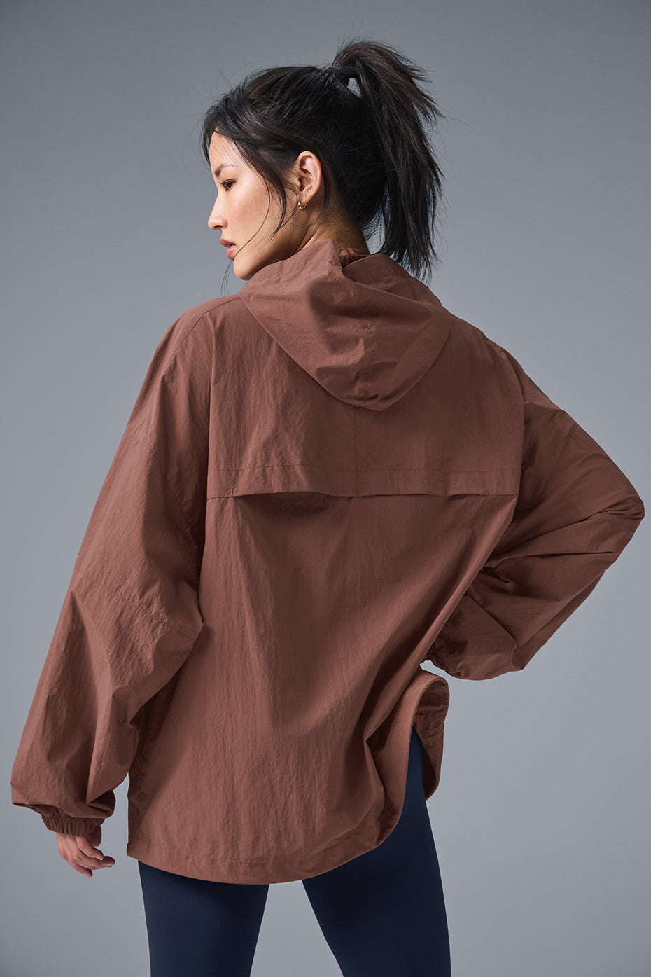 Vantage Nylon Ripstop Track Jacket in brown, showcasing structured hood and loose fit for running and training.
