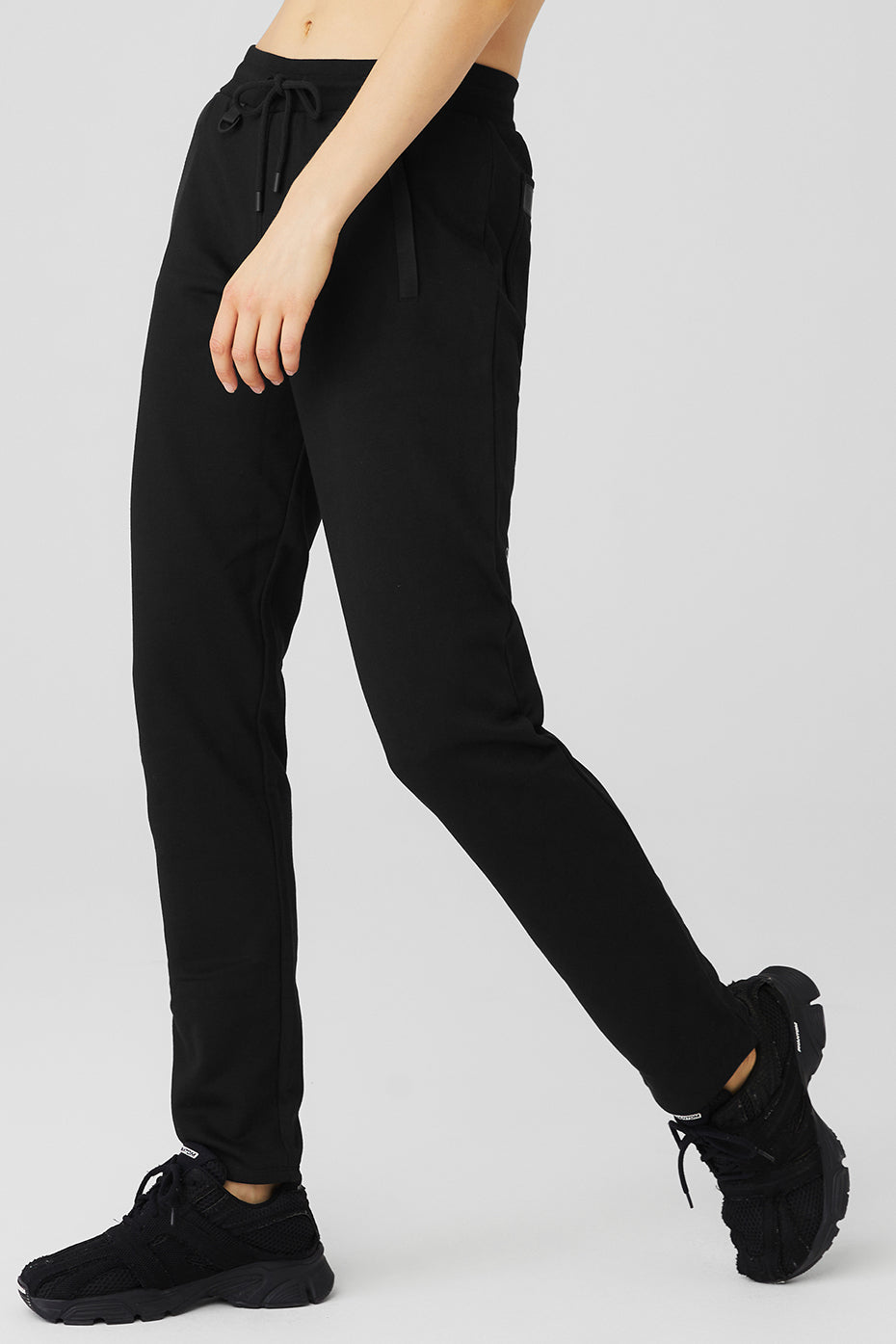 Nomadic Sweatpant in black designed for comfort with zippered pockets, perfect for workouts or casual outings.