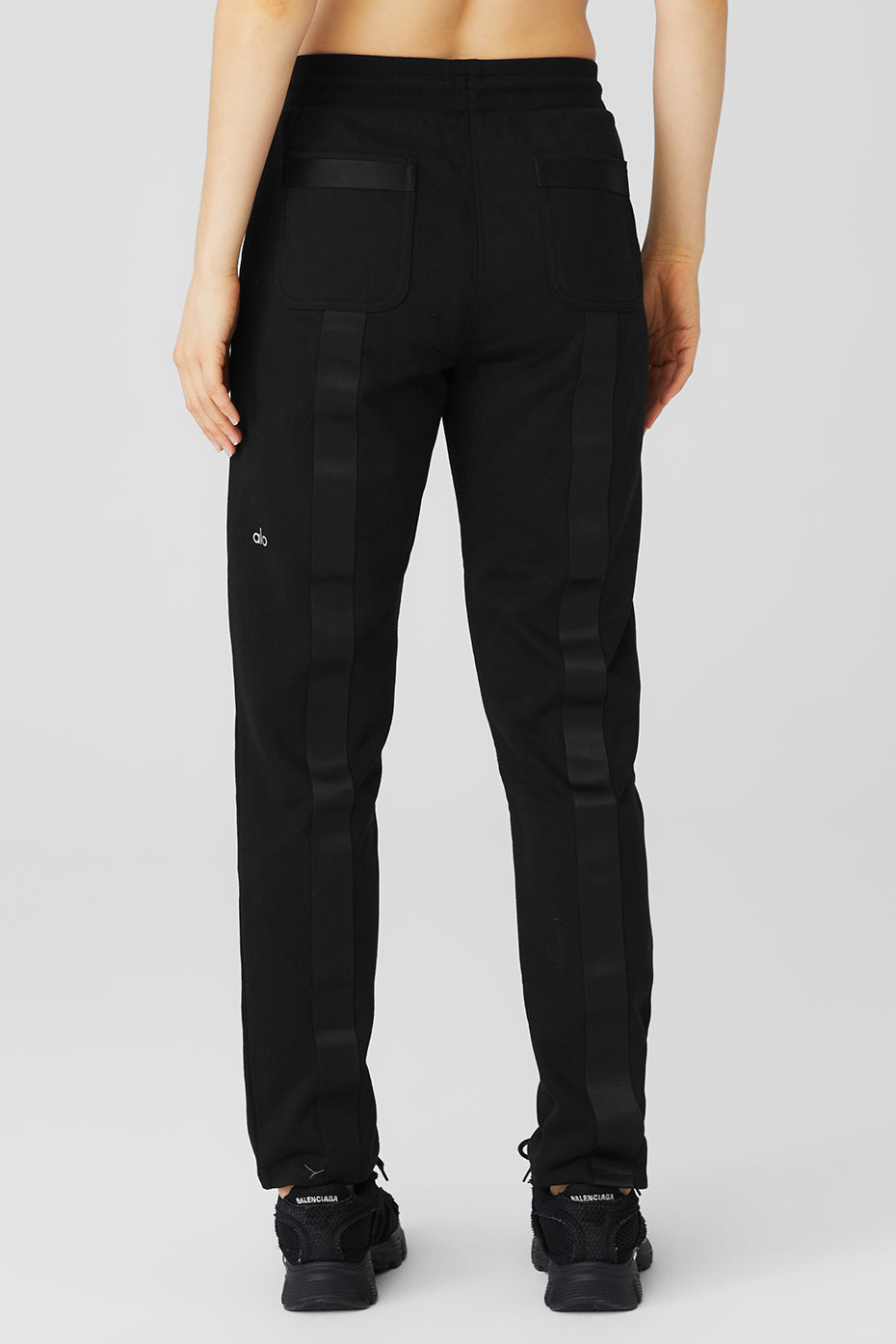 Back view of Nomadic Sweatpant featuring webbing details, secure zippered pockets, and comfortable fit.