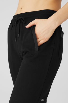 Close-up of Nomadic Sweatpant featuring zippered pockets and drawstring waistband for casual comfort.