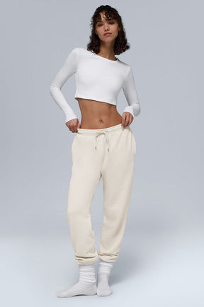Model wearing Chill Sweatpant with a white crop top, showcasing breathable fabric and side pockets.