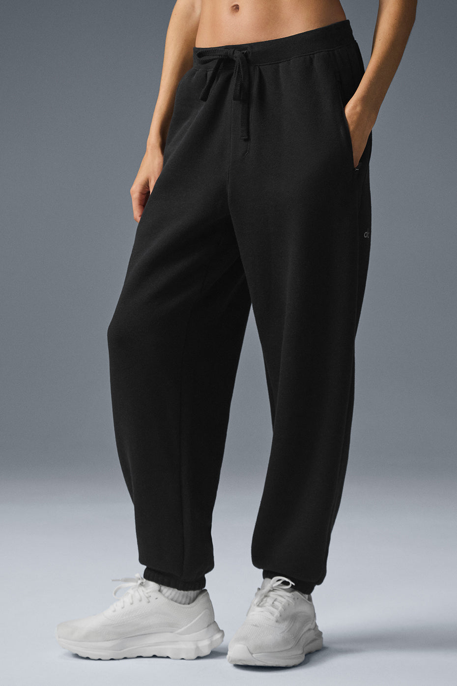 Triumph Restore Sweatpant in black, featuring zippered pockets and drawcord waist for a comfy oversized fit.
