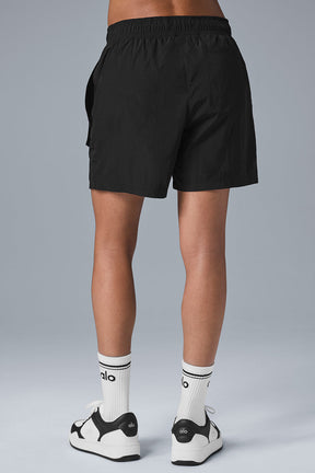 Back view of 7 inch black crinkle nylon excursion cargo shorts with comfortable drawstring waist