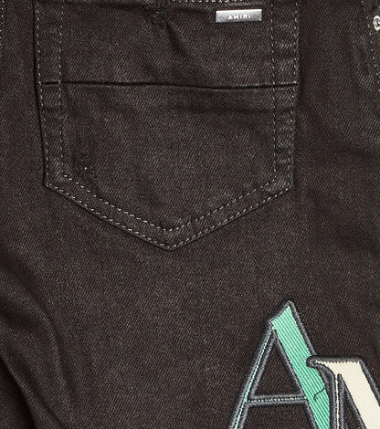 Distressed logo skinny jeans