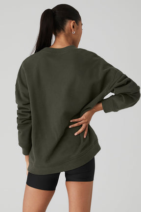 Back view of a model wearing a Renown Heavy Weight Crew Neck Pullover in olive green, showcasing the oversized fit.