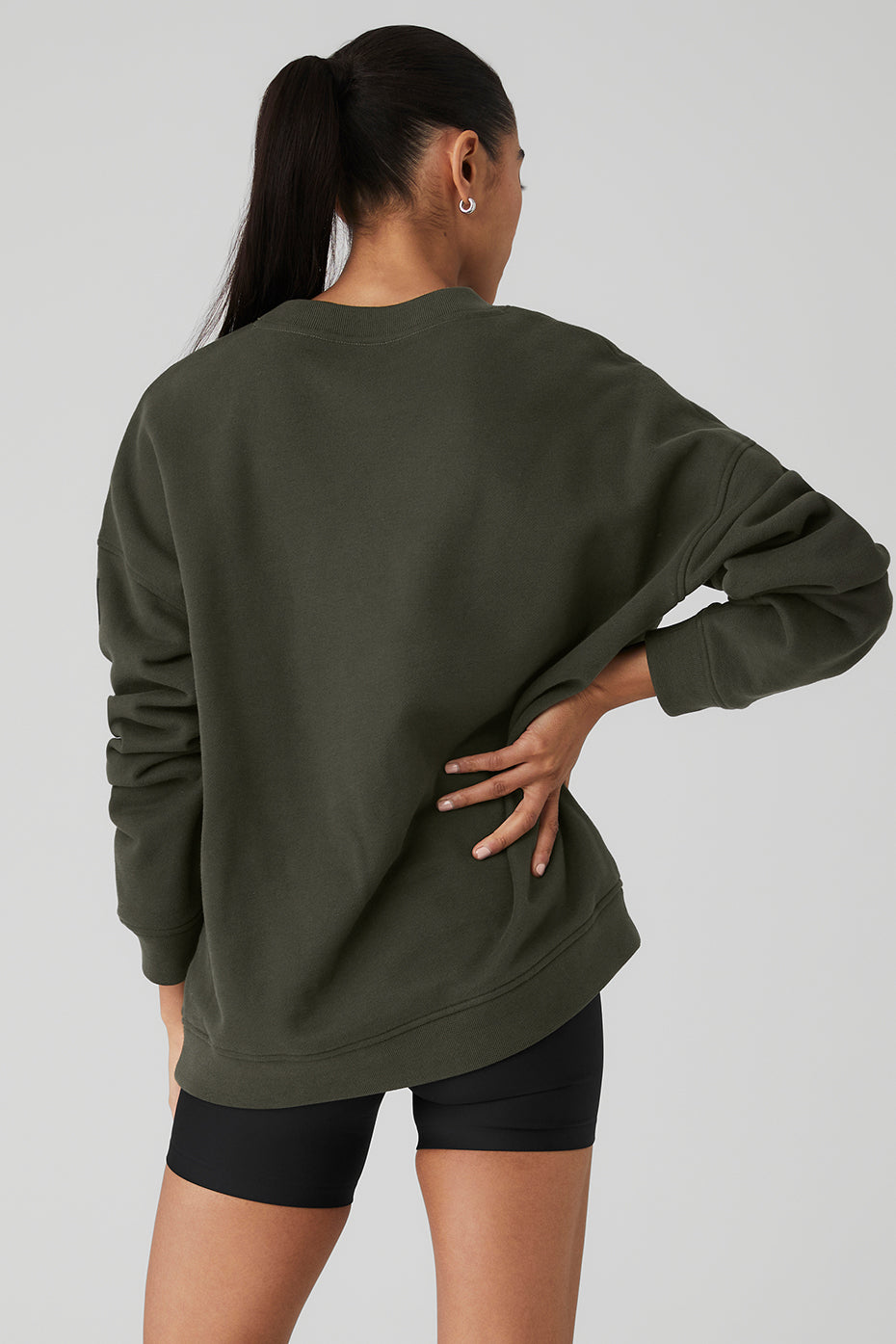Back view of a model wearing a Renown Heavy Weight Crew Neck Pullover in olive green, showcasing the oversized fit.