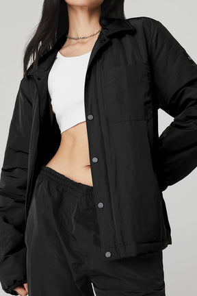 Legend Jacket in black featuring a sleek design, front pocket, and silhouette of a model in casual wear.
