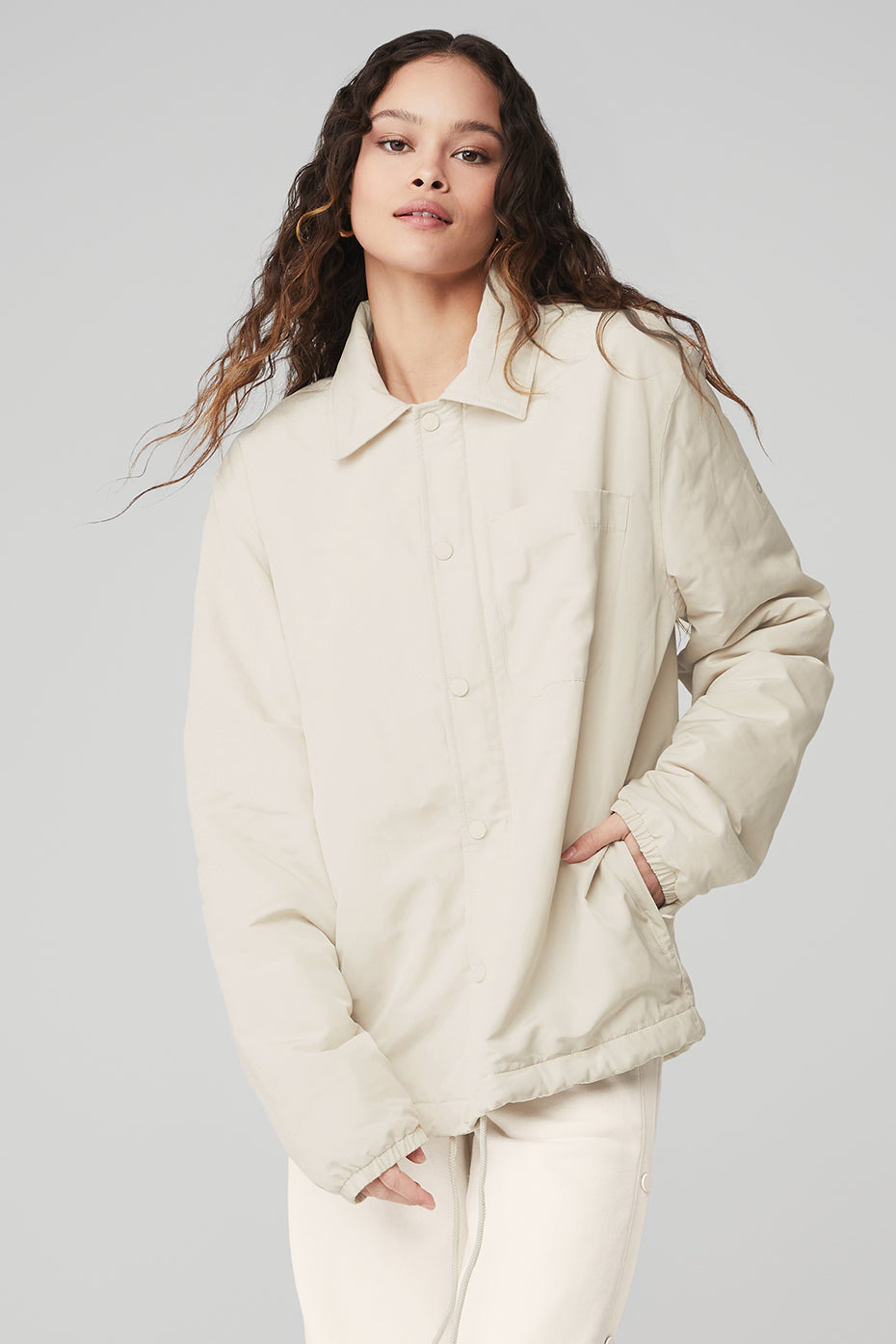 Legend Jacket in light fabric with a sleek collar, front pocket, and contemporary design. Perfect for all genders.