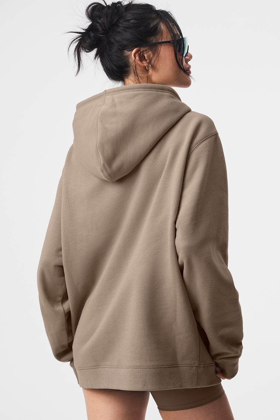 Back view of a woman wearing a Renown Full Zip Hoodie in soft heavyweight French terry with an oversized fit.