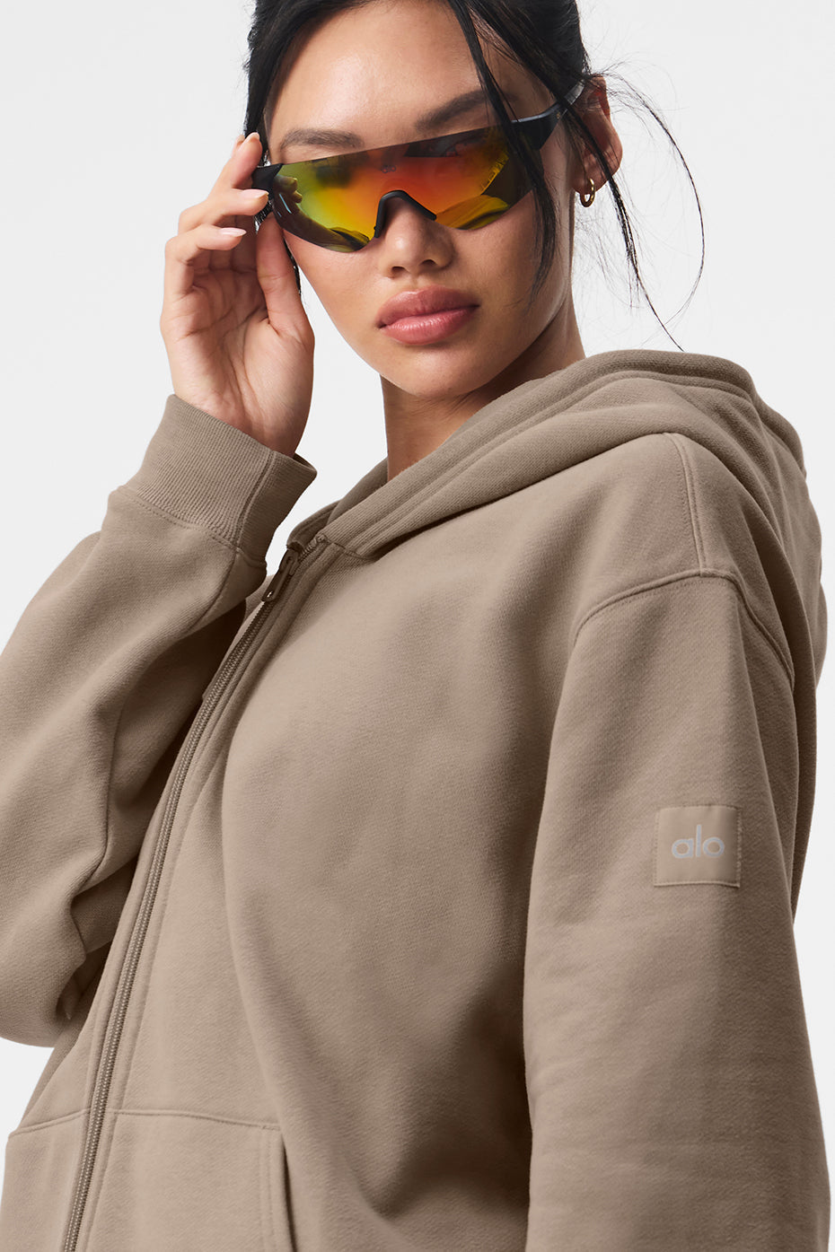 Model wearing Renown Full Zip Hoodie with oversized fit and sunglasses for casual style.