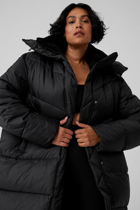 Model wearing oversized black Gold Rush Puffer trench with sherpa-lined collar, perfect for winter outerwear.