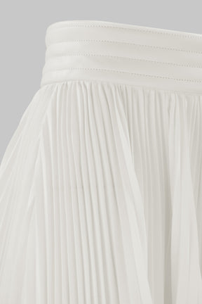 ASYMMETRIC PLEATED SKIRT W/ VEGAN LEATHER WAIST