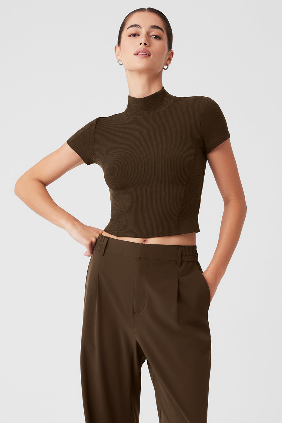Wellness Rib Mock Neck Polished Short Sleeve tee in olive, styled with tailored trousers for a chic look.