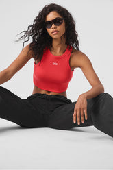 Aspire Tank in red, featuring a soft, cropped design and perfect fit, styled with black pants and sunglasses.