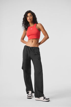 Model wearing a red cropped Aspire Tank with black pants, showcasing a stylish casual look for everyday wear.