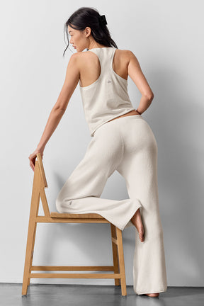 Woman wearing Supernatural Sweater Henley Tank and matching pants, showcasing a lightweight knit style and relaxed fit.