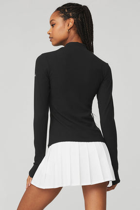 Wellness Rib Mock Neck Long Sleeve top in black, featuring a sleek design perfect for layering and stylish comfort.