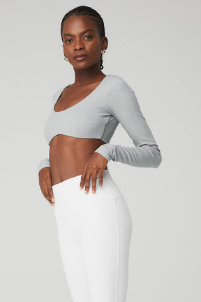 Model wearing gray Ribbed Defined Long Sleeve Bra with removable cups, showcasing a cropped fit and scoop neck design.