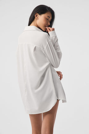 Model wearing the Dreamscape Button Down Long Sleeve, featuring a lightweight, oversized, collared design in breathable fabric.