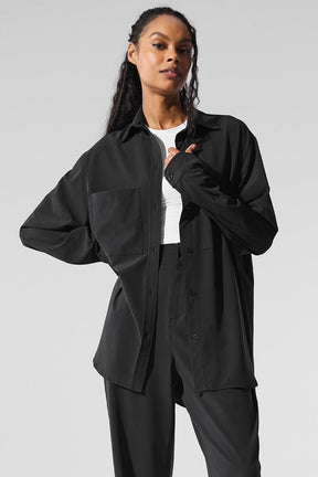 Dreamscape Button Down Long Sleeve in black featuring oversized fit, front pockets, and breathable crinkle woven fabric.