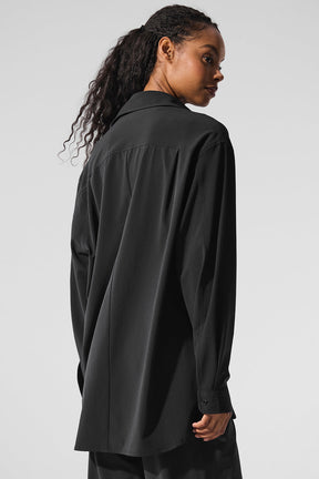 Back view of woman wearing Dreamscape Button Down Long Sleeve shirt in black, showcasing lightweight and breathable design.