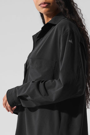 Dreamscape Button Down Long Sleeve shirt in black with oversized fit and front pocket, featuring a collared design.