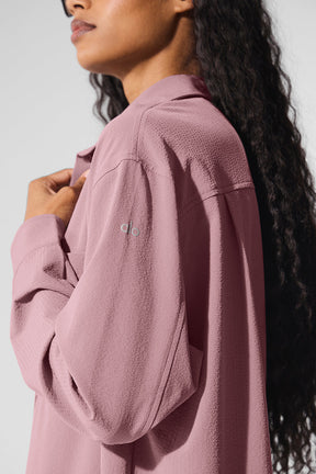 Dreamscape Button Down Long Sleeve in pink, featuring a breathable crinkle woven fabric and front pockets.
