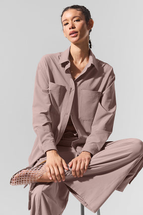Model wearing the Dreamscape Button Down Long Sleeve in lightweight fabric with front pockets and collared design.