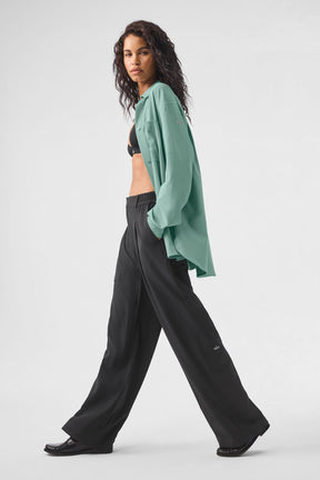 Model wearing the Dreamscape Button Down Long Sleeve with High-Waist Dreamscape Trousers in a stylish walk.