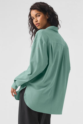 Model wearing the Dreamscape Button Down Long Sleeve in mint green, featuring a relaxed fit and breathable fabric.