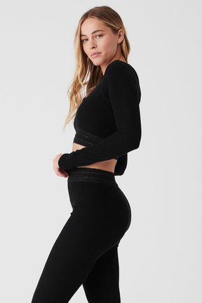 Model wearing black Seamless Luxe Terry Cuddle Coverup with matching pants showcasing warmth and comfort.