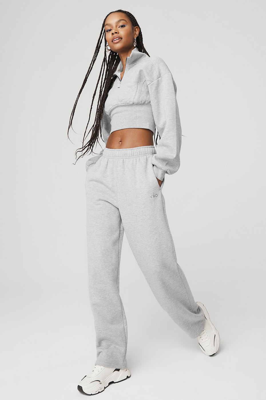 Model wearing a gray Vixen Fleece 1/4 zip pullover with matching pants, showcasing a 90s-inspired style and flattering fit.