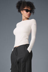 Model wearing Ribbed Sea Coast Long Sleeve shirt with black pants, showcasing soft fabric and versatile style.