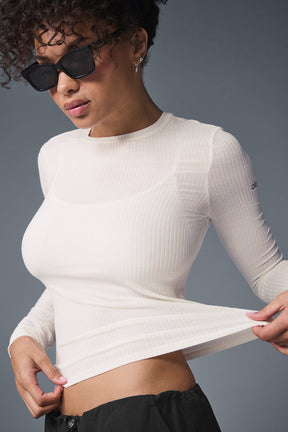 Model wearing a Ribbed Sea Coast Long Sleeve shirt in white, showcasing its soft, stretchy fabric and slim fit.
