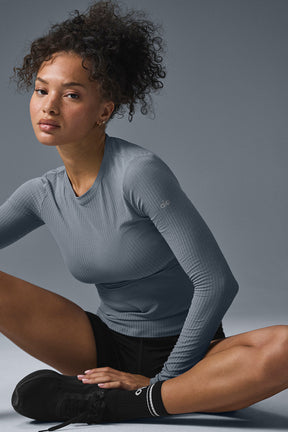 Model wearing a ribbed sea coast long sleeve shirt paired with athletic shorts, showcasing soft and versatile style.