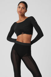 Model wearing a Mesh Sheer Illusion cropped long sleeve top with gathered front and boat neck paired with high-rise pants.