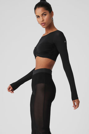 Model showcasing a Mesh Sheer Illusion Cropped Long Sleeve top with boat neck and gathered front.