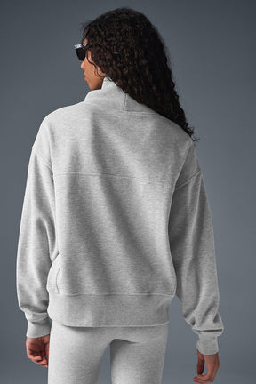 Back view of a model wearing a soft gray Hazy Mock Neck Pullover sweater in an oversized fit.