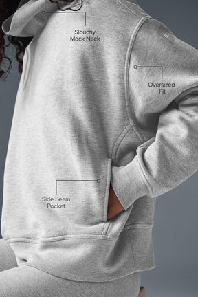 Hazy Mock Neck Pullover showing slouchy mock neck, oversized fit, and side seam pocket in cozy gray fabric.