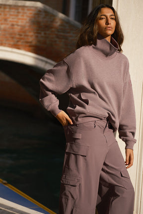 Hazy mock neck pullover sweater styled with oversized cargo pants for a cozy, laid-back look.