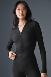 Ribbed Mesmerize Long Sleeve top with invisible zipper in black, featuring a close-to-body fit and v-neck design for versatile styling.