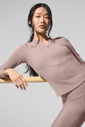 Ribbed Mesmerize Long Sleeve top in mauve, featuring a front zipper and close-to-body fit, perfect for layering.