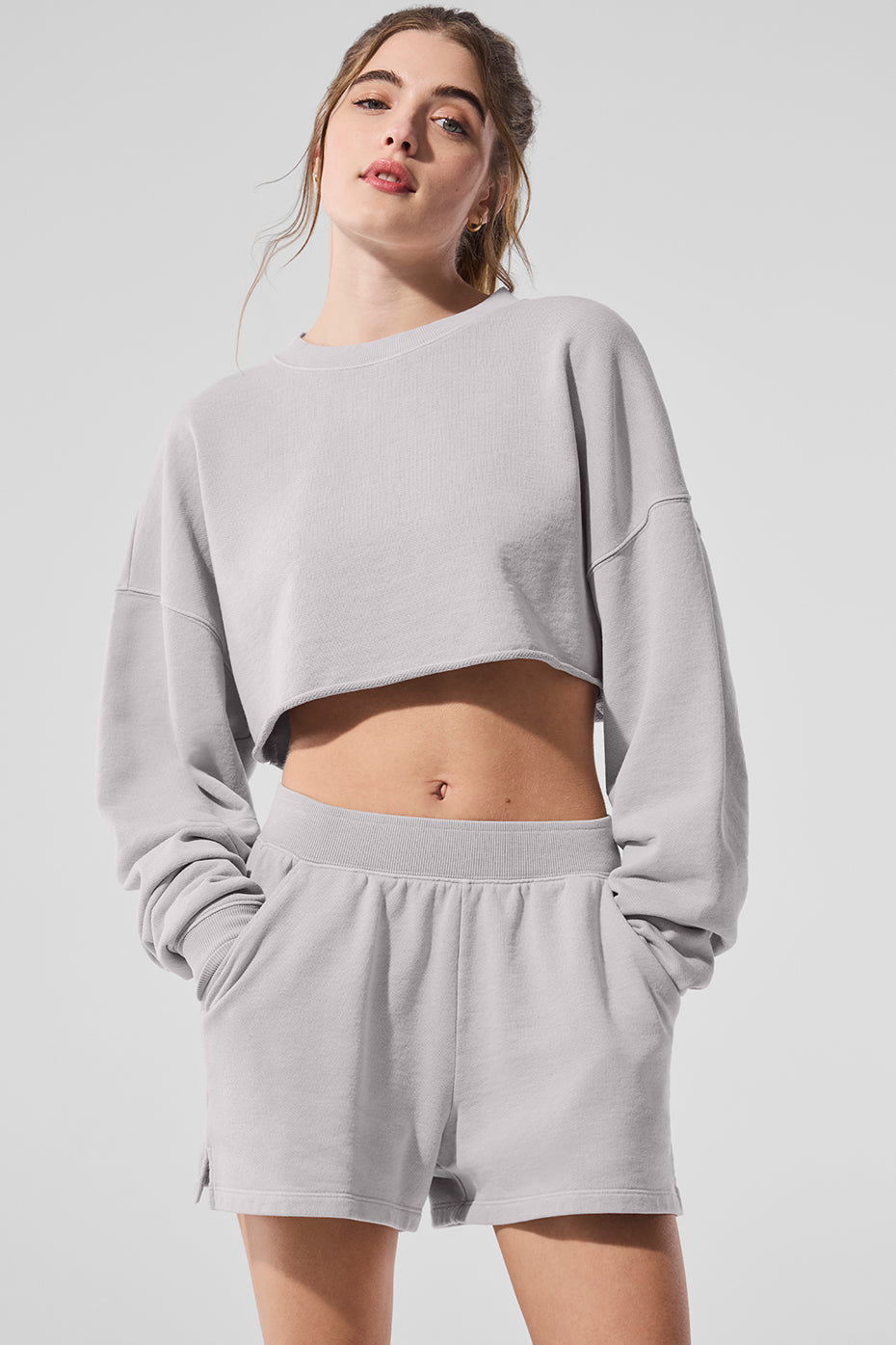 Washed extreme cropped pullover in gray, styled with matching shorts for a chic studio-to-street look.