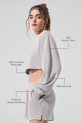 Model showcasing Washed Extreme Cropped Pullover in soft French terry with an ultra-cropped silhouette and sunburst sleeve detailing.