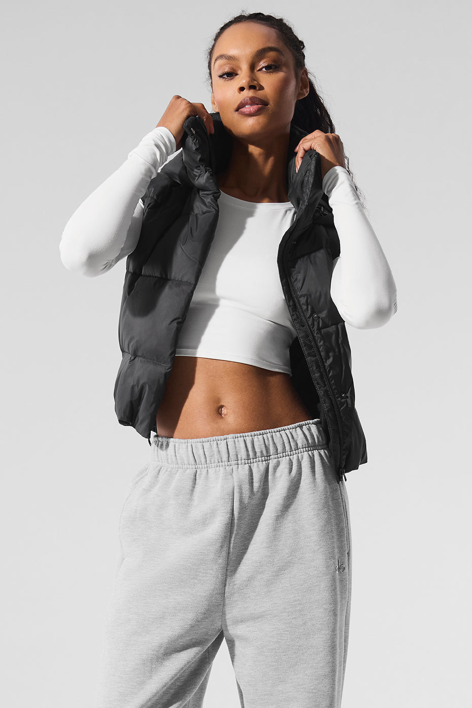 Model showcasing a cozy-luxe Gold Rush Puffer Vest with a hooded collar, perfect for stylish layering and warmth.