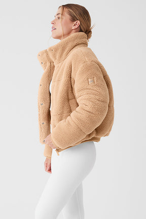 Sherpa Snow Angel Puffer, plush fur jacket with a tall collar and deep pockets, perfect for warmth during outdoor activities.