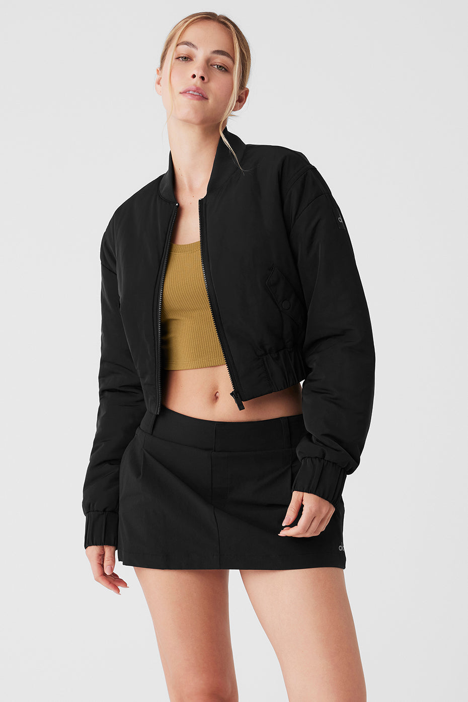 Cropped Break Line Bomber Jacket in black, featuring ribbed collar, cuffs, and two front snap pockets.