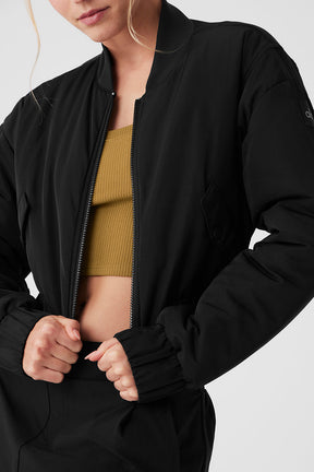 Cropped Break Line Bomber Jacket in black with ribbed collar and two front snap pockets, perfect for stylish outings.