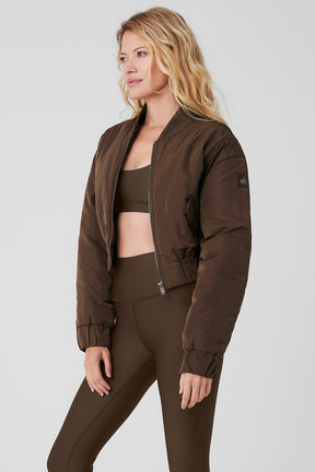 Cropped Break Line Bomber Jacket in brown, showcasing a ribbed collar and two front snap pockets.