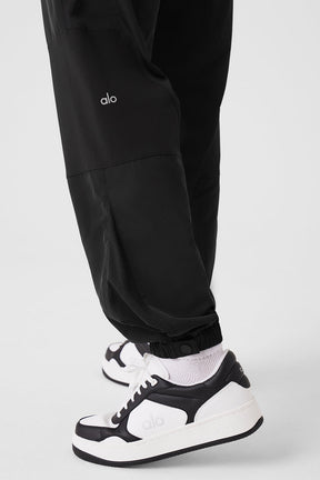 Close-up of Mixed Media Reinvention Jogger featuring stretchy cuffs and sporty design paired with stylish sneakers.